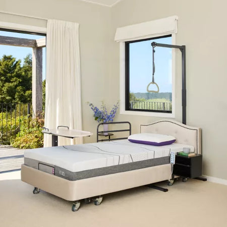 Bed with adjustable headboard in a room with large windows and outdoor view