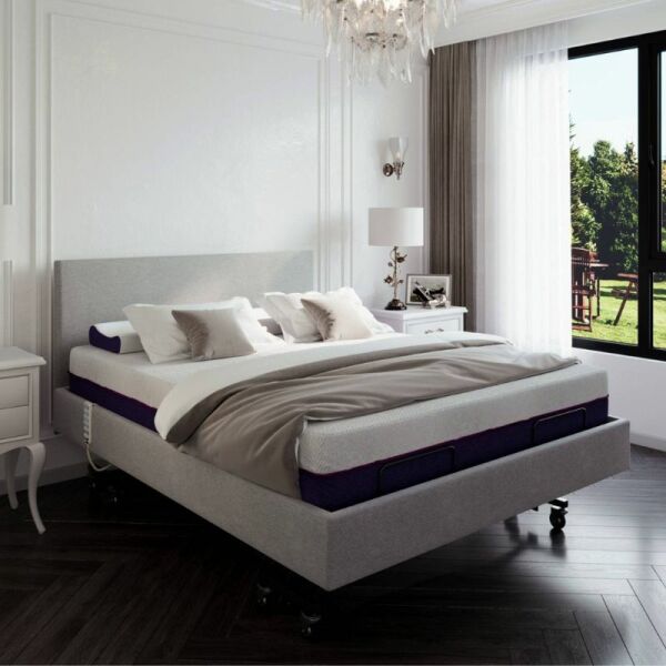Modern bedroom with a bed and nightstands, featuring a large window.
